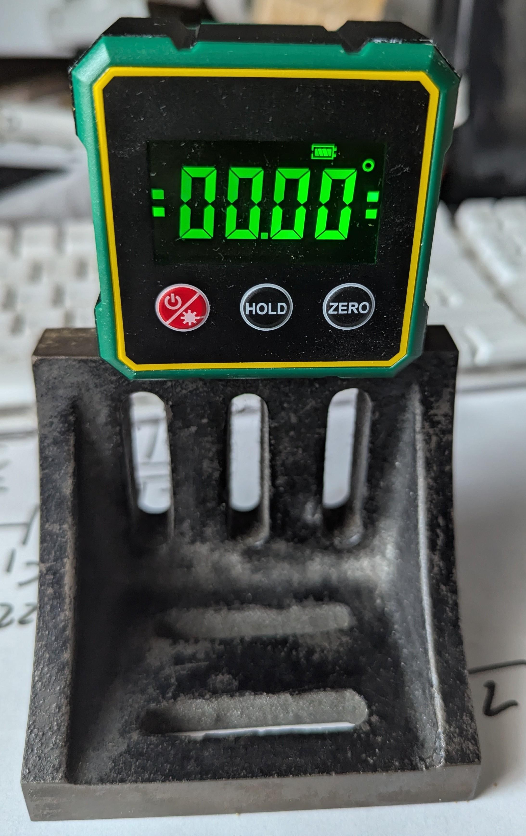 The angle measuring device sitting on a machine angle plate top surface reading 0000 °