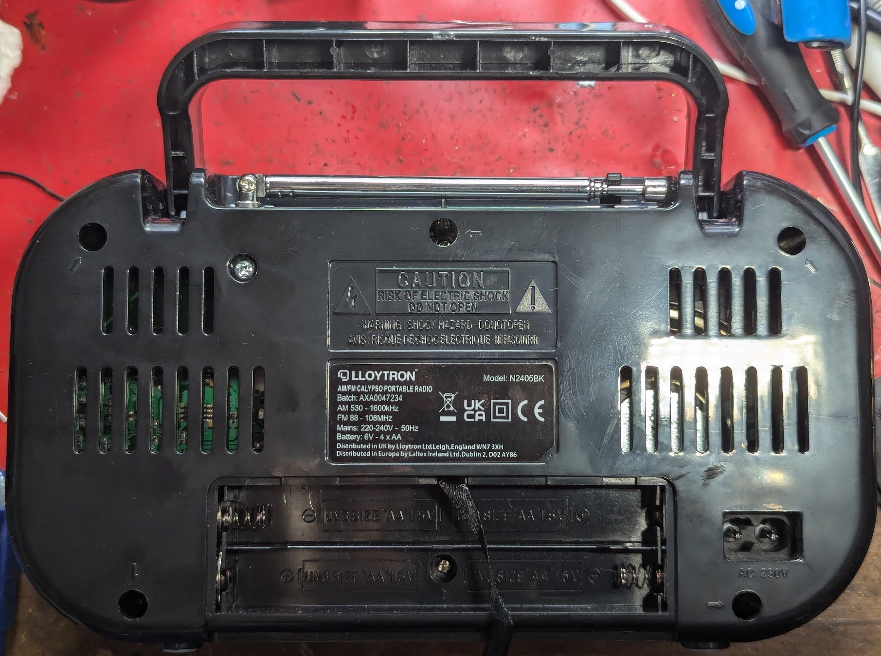 The back of the radio showing screw holes, one is hidden inside the battery area