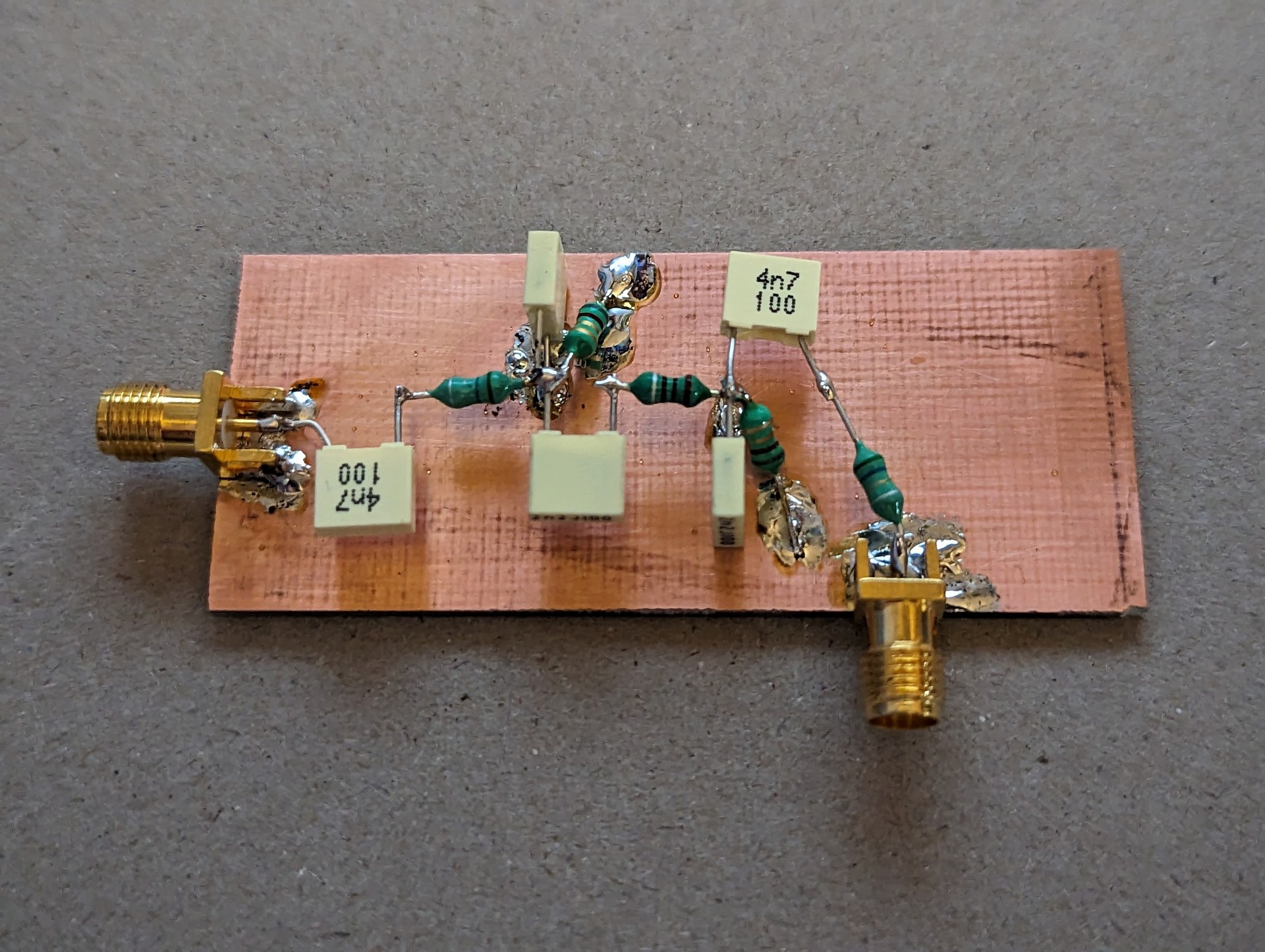 The filter constructed on some copper clad board. Input is to the left, output is on the bottom of the board