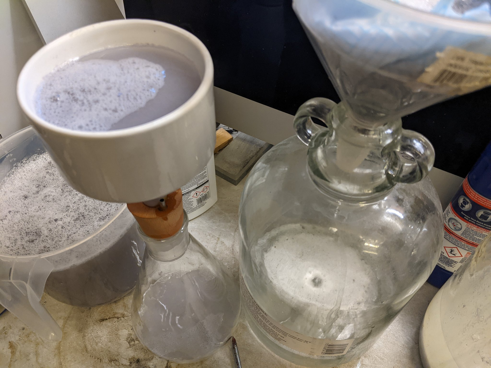 Filtering hot bleach solution to recover the silver chloride
